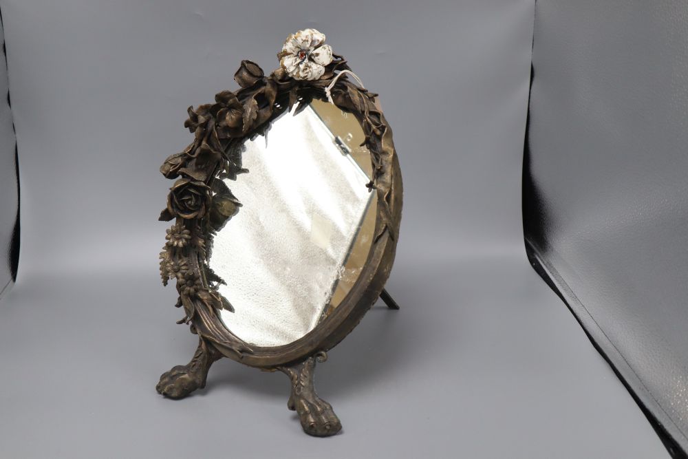 A floral bronze oval easel mirror, with single enamelled flower, length 41cm